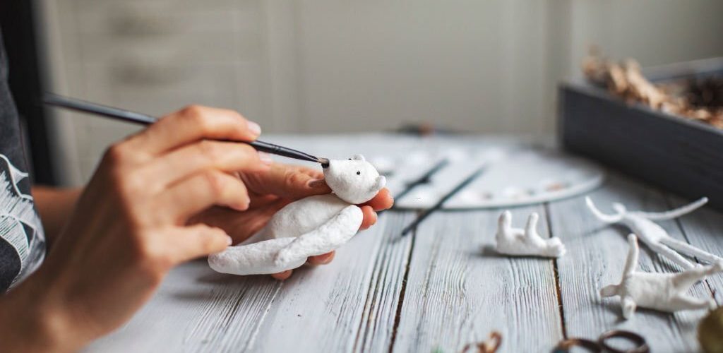 Woman making wool soft toys