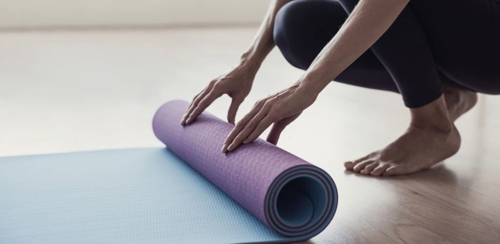 Young woman meditating at home. Girl practicing yoga in class. Relaxation, body care, healthy lifestyle, exercising, home workout, pilates, fitness, training concept
